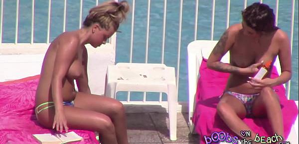  Topless sisters tanned and oiled up with pierced nipple & tattoos 1of3
